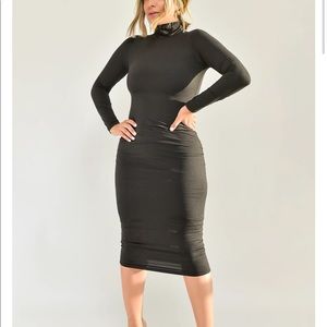 Turtle neck, long sleeve, mid length dress.
